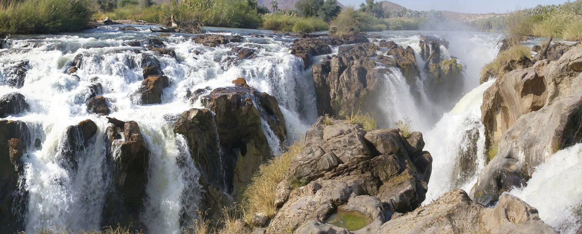 White water pouring through dark rocks at Epupa Falls on the Kunene River