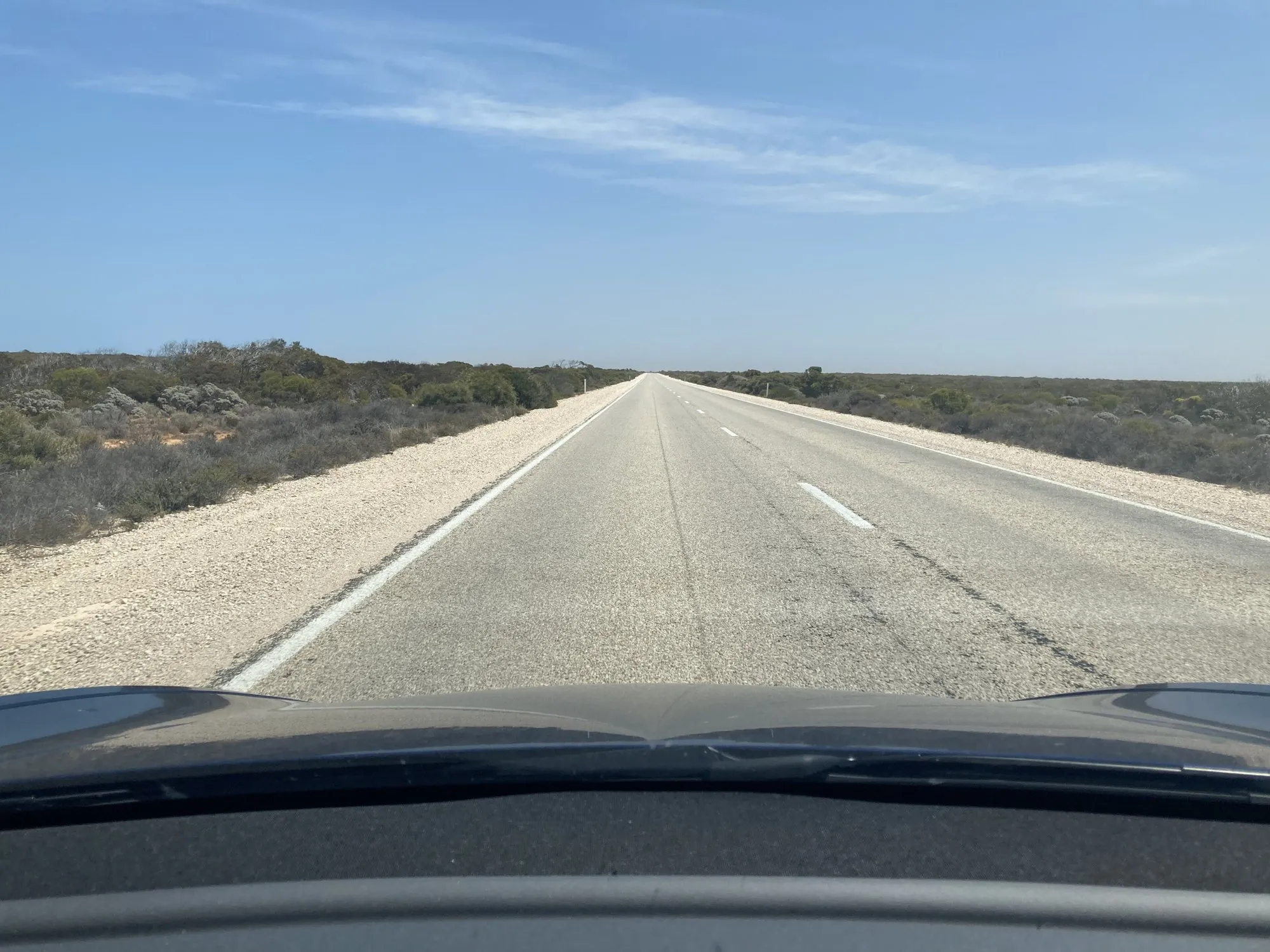 An empty, straight Eyre Highway across the flat Nullarbor Plain