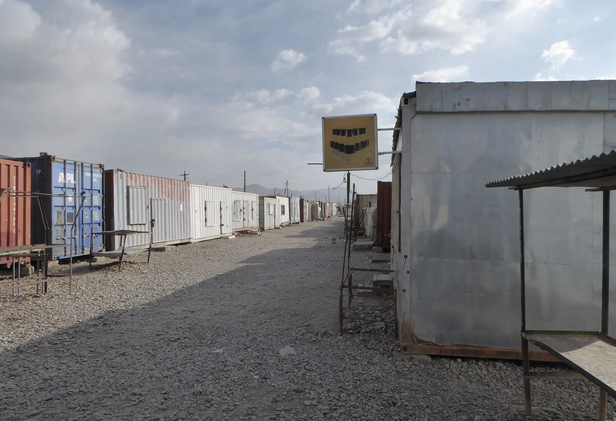 A row of shipping containers used as shops in Murghab's bazaar