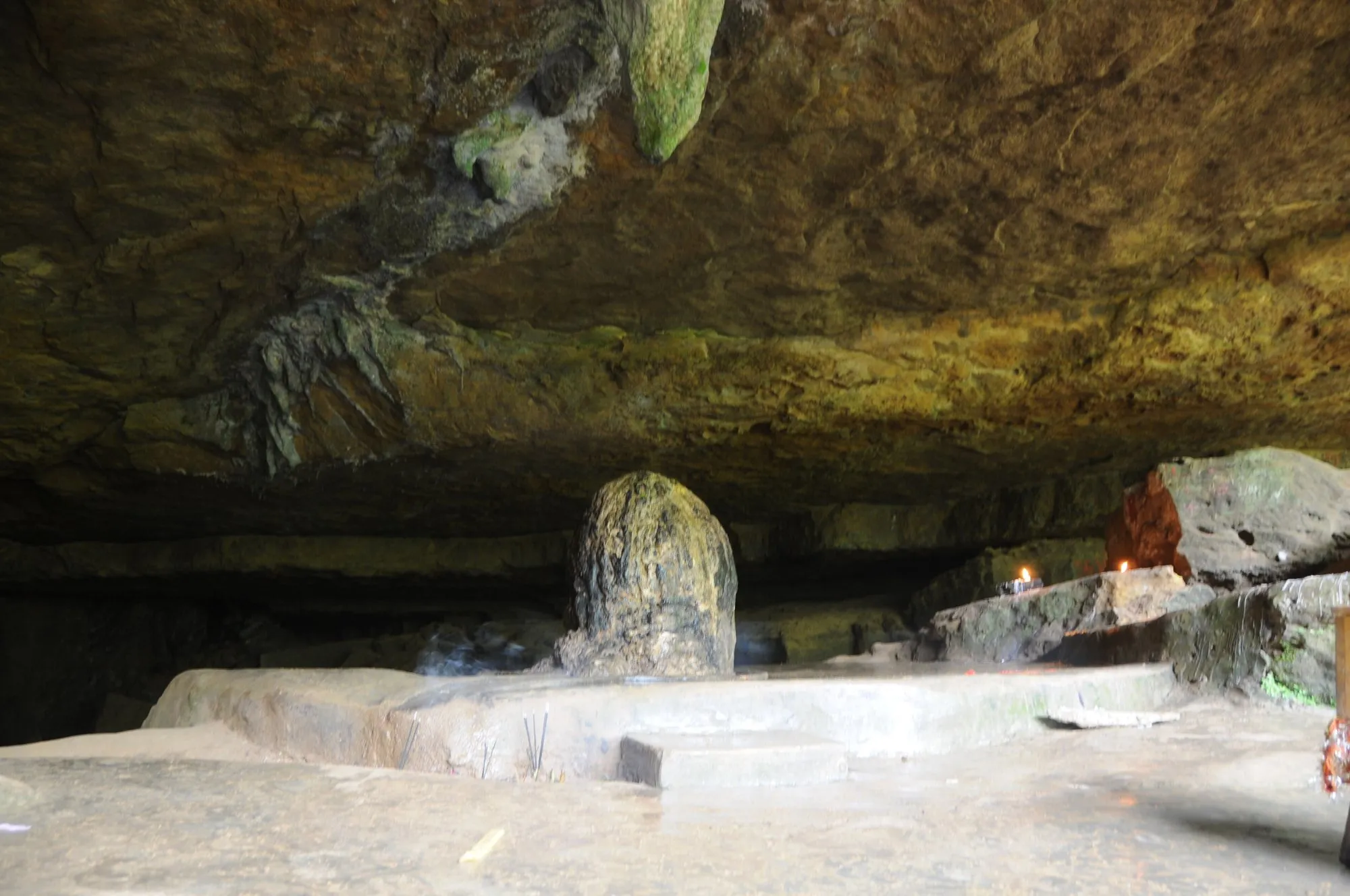 A rounded stalagmite under a low limestone overhang inside Mawjymbuin Cave