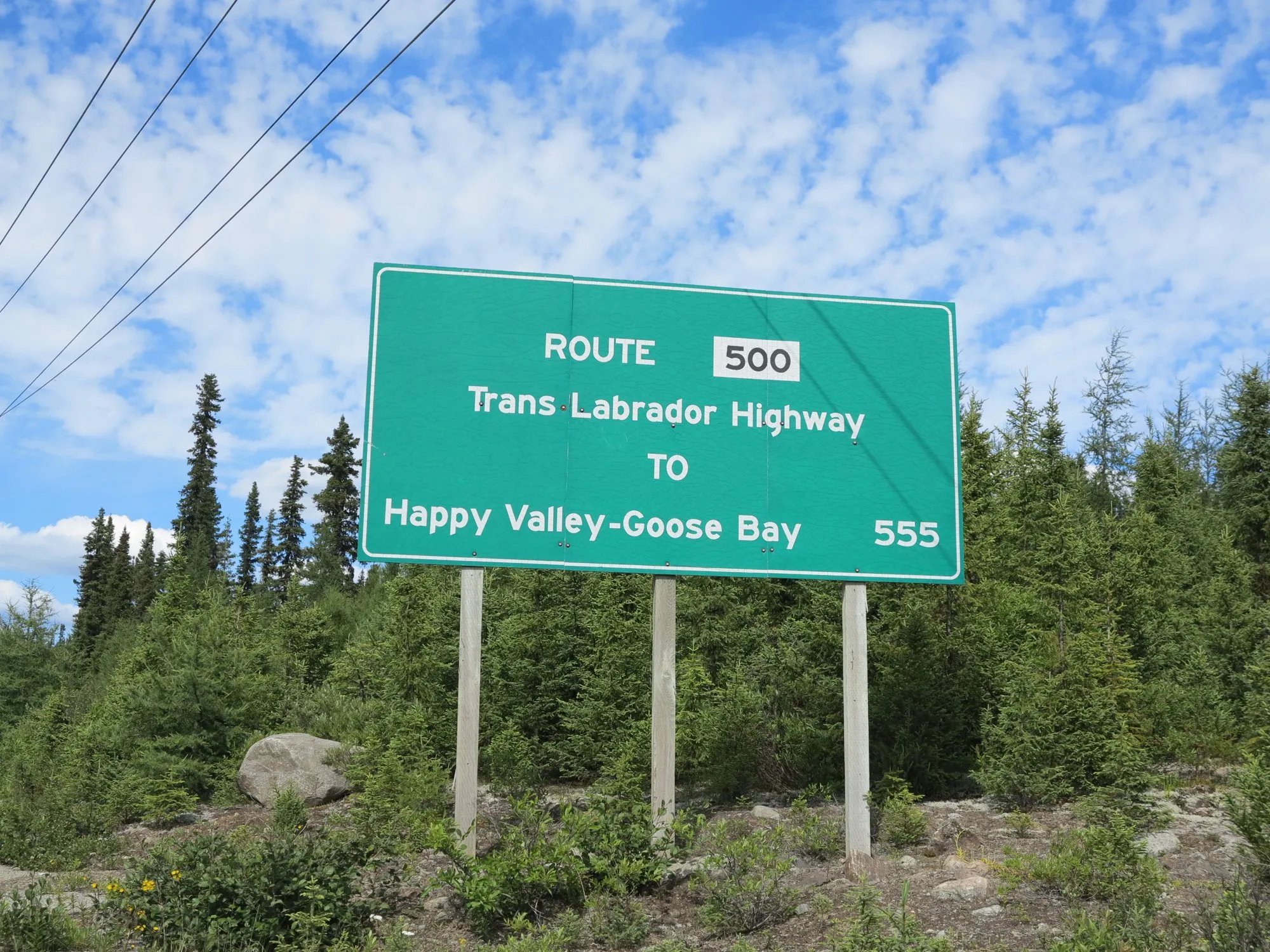 A green Route 500 sign: Happy Valley-Goose Bay 555 km